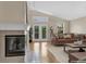 Bright living room with hardwood floors, fireplace, and double doors leading to the outside at 1606 Iris St, Broomfield, CO 80020