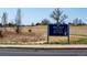 Entrance to Ellie's Pond at The Field in Broomfield Open Space with path and trees at 1606 Iris St, Broomfield, CO 80020