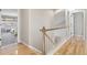 Upstairs hallway with wood floors and white trim leading to bedrooms and bathrooms at 3662 Castle Peak Ave, Superior, CO 80027