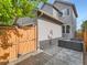 This property's backyard features a wood fence and gate, an outdoor seating area, and string lights at 10479 E 25Th Dr, Aurora, CO 80010