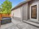 The property's backyard features a concrete patio, an exterior door, and subtle overhead string lights at 10479 E 25Th Dr, Aurora, CO 80010