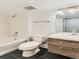 Modern bathroom featuring a shower and bathtub combo, and a wood-finished vanity with a sink at 10479 E 25Th Dr, Aurora, CO 80010