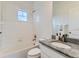 Bathroom featuring a bathtub and shower combination with a granite countertop sink at 10479 E 25Th Dr, Aurora, CO 80010