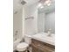 Modern bathroom featuring a shower and bathtub combo, and a wood-finished vanity with a sink at 10479 E 25Th Dr, Aurora, CO 80010