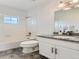 Bathroom featuring a vanity with a granite countertop, a sink, and a bathtub with white tile at 10479 E 25Th Dr, Aurora, CO 80010