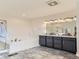 Modern bathroom featuring a double vanity, soaking tub, and glass enclosed shower at 10479 E 25Th Dr, Aurora, CO 80010