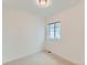 This simple bedroom has white walls, carpet, and a small window at 10479 E 25Th Dr, Aurora, CO 80010