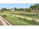 The community features a playground and a green space, with a walking path going through it at 10479 E 25Th Dr, Aurora, CO 80010