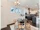 Dining room showcasing modern chandelier and view of kitchen with stainless appliances at 10479 E 25Th Dr, Aurora, CO 80010