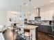 Modern kitchen boasts granite countertops, stainless steel appliances, and stylish two-tone cabinetry at 10479 E 25Th Dr, Aurora, CO 80010