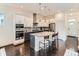 Contemporary kitchen featuring two-tone cabinets, stainless steel appliances, and a granite island at 10479 E 25Th Dr, Aurora, CO 80010