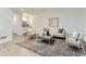 Living room with modern sofa and a decorative area rug on gray laminate flooring at 10479 E 25Th Dr, Aurora, CO 80010