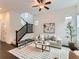 Cozy living room with modern decor, plush seating, and staircase at 10479 E 25Th Dr, Aurora, CO 80010