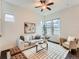 Bright living room featuring a ceiling fan, plush sofa, stylish rug and decorative artwork at 10479 E 25Th Dr, Aurora, CO 80010