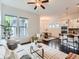 Bright living room featuring large windows, an open layout, and seamless flow to the kitchen at 10479 E 25Th Dr, Aurora, CO 80010