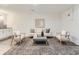 Living room with matching chairs, modern sofa and a decorative area rug on gray laminate flooring at 10479 E 25Th Dr, Aurora, CO 80010
