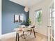 Cozy office space featuring a desk, chair, natural light, and a blue accent wall at 10479 E 25Th Dr, Aurora, CO 80010