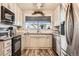 Bright kitchen featuring white cabinets and stainless steel appliances at 23406 E 5Th Pl # 203, Aurora, CO 80018