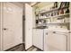 Laundry room with washer, dryer, and storage shelves at 23406 E 5Th Pl # 203, Aurora, CO 80018
