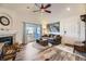 Living room with fireplace, balcony access, and wood-look floors at 23406 E 5Th Pl # 203, Aurora, CO 80018