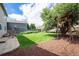 Spacious backyard featuring a lush lawn, a charming treehouse, and a wood fence for privacy at 5573 S Taft St, Littleton, CO 80127