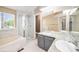 Bright bathroom with granite counters, soaking tub, stand up shower, and modern finishes at 5573 S Taft St, Littleton, CO 80127