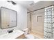 Cozy bathroom featuring a tub shower, large mirror, and contemporary fixtures at 5573 S Taft St, Littleton, CO 80127