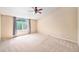 Spacious bedroom with carpet, a large window, ceiling fan, and neutral walls at 5573 S Taft St, Littleton, CO 80127