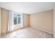 Bright bedroom with carpet, a vaulted ceiling, and a large window with curtains at 5573 S Taft St, Littleton, CO 80127