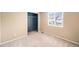 Comfortable bedroom with neutral walls, carpet flooring, closet, and a sun-lit window at 5573 S Taft St, Littleton, CO 80127