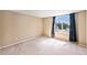 Sun-lit bedroom featuring carpet, a vaulted ceiling, and a large window with curtains at 5573 S Taft St, Littleton, CO 80127