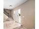 Inviting entryway with tile flooring, staircase, and a white front door at 5573 S Taft St, Littleton, CO 80127