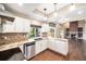 Modern kitchen featuring stainless steel appliances, granite countertops, and white cabinetry at 5573 S Taft St, Littleton, CO 80127