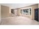 Bright living room featuring a large bay window offering natural light and neutral color palette at 5573 S Taft St, Littleton, CO 80127