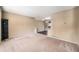 Open living room with neutral walls, carpet, and access to the dining room at 5573 S Taft St, Littleton, CO 80127