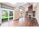 Comfortable living room with hardwood floors, a cozy fireplace, and a sliding glass door to the backyard at 5573 S Taft St, Littleton, CO 80127