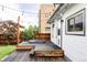 Cozy backyard featuring a wooden deck with a hot tub and string lights at 4421 Raleigh St, Denver, CO 80212