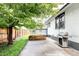 Backyard featuring a concrete patio with a grill and a wooden garden bed at 4421 Raleigh St, Denver, CO 80212
