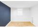Clean basement space with a painted accent wall and a bright window at 4421 Raleigh St, Denver, CO 80212