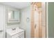 Bathroom featuring a tiled shower and a vanity with a mirror at 4421 Raleigh St, Denver, CO 80212