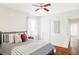 Comfortable bedroom featuring hardwood floors, and a cozy bed with decorative pillows at 4421 Raleigh St, Denver, CO 80212