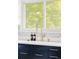Bright kitchen sink with a gold faucet, soap dispenser, and a large window at 4421 Raleigh St, Denver, CO 80212
