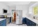 Modern kitchen with stainless steel appliances and white cabinets at 4421 Raleigh St, Denver, CO 80212