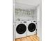 Modern laundry room features a stacked washer and dryer at 4421 Raleigh St, Denver, CO 80212
