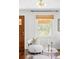 Bright living room with a stylish chair and window with natural light at 4421 Raleigh St, Denver, CO 80212