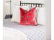 Cozy main bedroom decor, featuring a red decorative pillow, and black and white patterned bedding at 4421 Raleigh St, Denver, CO 80212