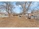 A view of the spacious backyard with mature trees at 75 Vrain St, Denver, CO 80219