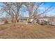 Large backyard featuring mature trees, shed, and plenty of space at 75 Vrain St, Denver, CO 80219