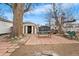 View of the brick patio, bench, and storage sheds in the spacious backyard at 75 Vrain St, Denver, CO 80219