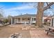 The spacious backyard shows a brick patio, fire pit, and mature trees at 75 Vrain St, Denver, CO 80219